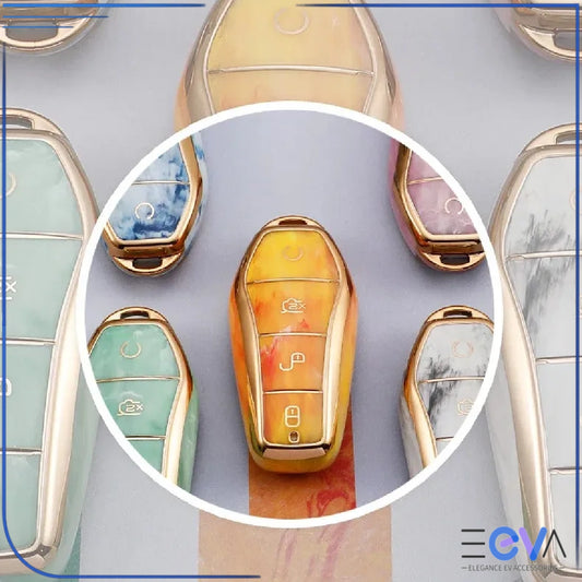 BYD car key case in fire opal orange gemstone finish with gold edging, shown in a clean studio view from EEVA Store Australia.