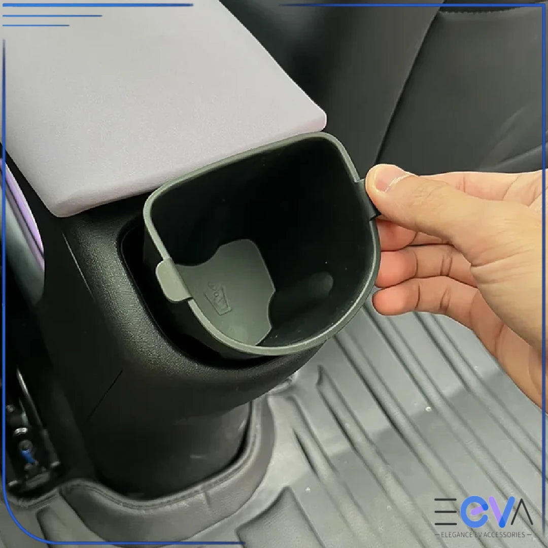 BYD Dolphin rear armrest cup holder insert being installed by hand, showing easy removal and secure fit from EEVA Store Australia.