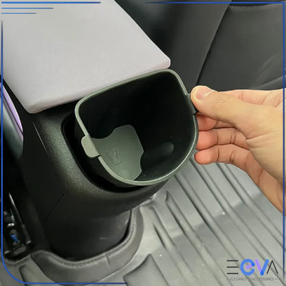 BYD Dolphin rear armrest cup holder insert being installed by hand, showing easy removal and secure fit from EEVA Store Australia.
