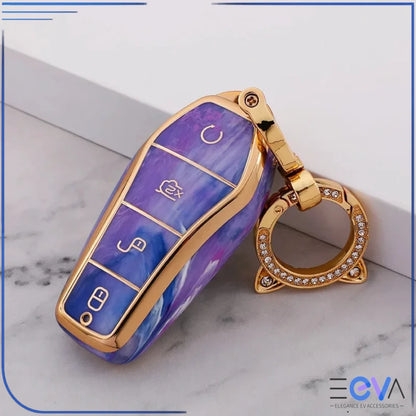BYD car key case in amethyst purple with cat ear buckle keychain, showing luxury gold frame and smooth finish from EEVA Store Australia.