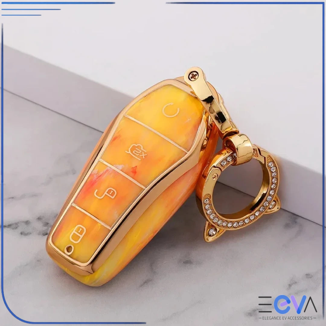 BYD car key case in fire opal orange with cat ear buckle keychain, displayed in a studio close-up from EEVA Store Australia.