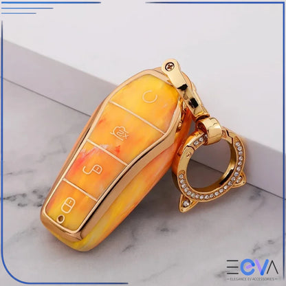 BYD car key case in fire opal orange with cat ear buckle keychain, displayed in a studio close-up from EEVA Store Australia.
