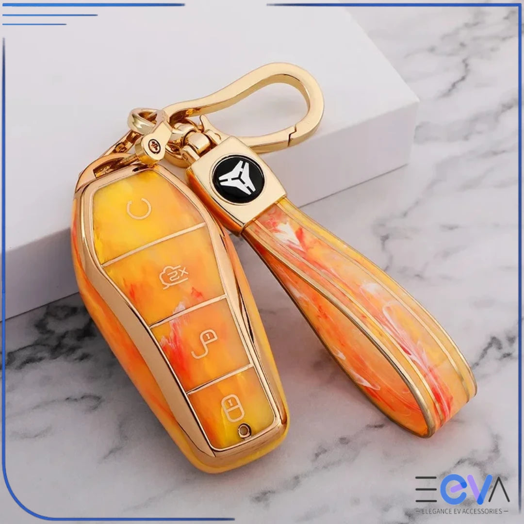 BYD car key case in fire opal orange gemstone style with strap keychain, showing vibrant colour and premium gold trim from EEVA Store Australia.