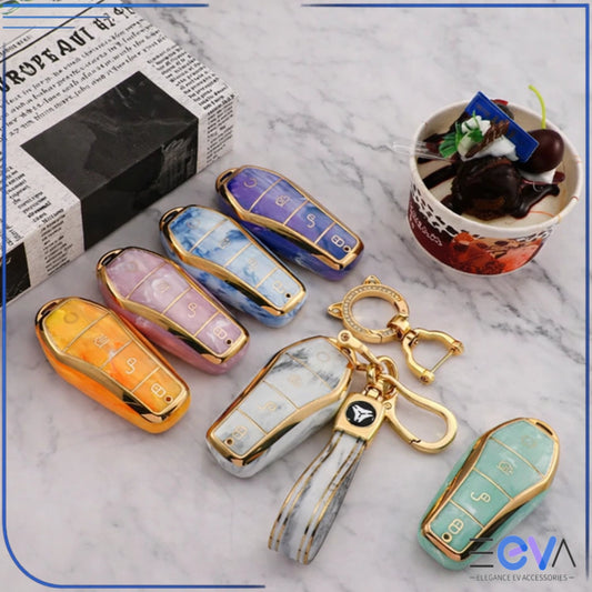 BYD car key case gemstone style set showing multiple colour options with gold trim in a flat lay from EEVA Store Australia.