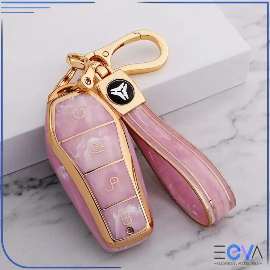BYD car key case in pink tourmaline with strap keychain attached, showing glossy gemstone look and gold trim from EEVA Store Australia.